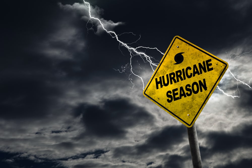 Hurricane season warning sign with approaching storm clouds, highlighting disaster preparedness, emergency planning, weather safety, and storm readiness for families and pets.